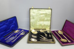 A cased pair of large engraved plated spoons and two other cased silver plated flatware sets