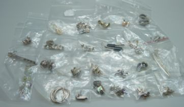 Twenty-five pairs of silver earrings