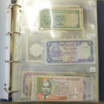 A blue album of circulated bank notes, Maruitius, Singapore, Zambia, etc.