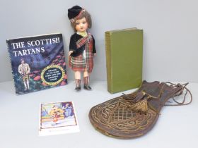 An antique Scottish leather bag/sporran, a vintage Scottish highland dressed doll, a book of