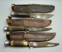 Three hunting knives with scabbards, one marked Rodgers, Sheffield