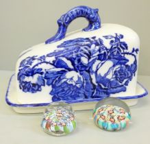 A pair of millefiori glass paperweights and a blue and white cheese dish