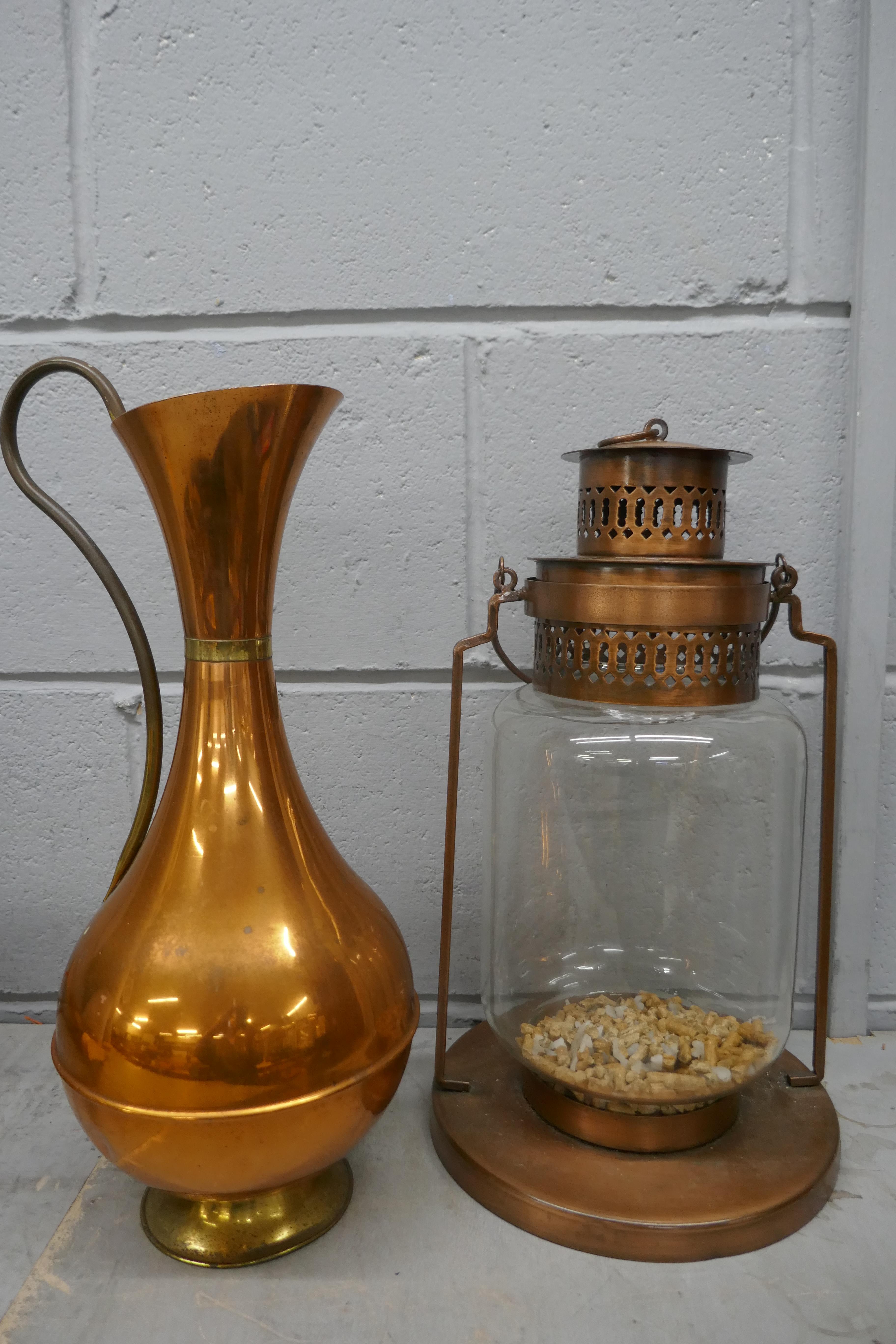 A metal lamp and a copper jug **PLEASE NOTE THIS LOT IS NOT ELIGIBLE FOR POSTING AND PACKING**