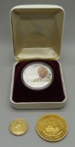 A boxed silver one dollar Pope John Paul II coin, a $10 Liberia silver coin and an 1887 Victoria The