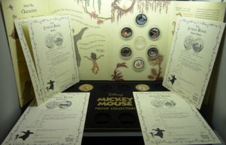 A Disney Jungle Book 50p colour collection (6 coins) in packaging, and two Mickey Mouse proof