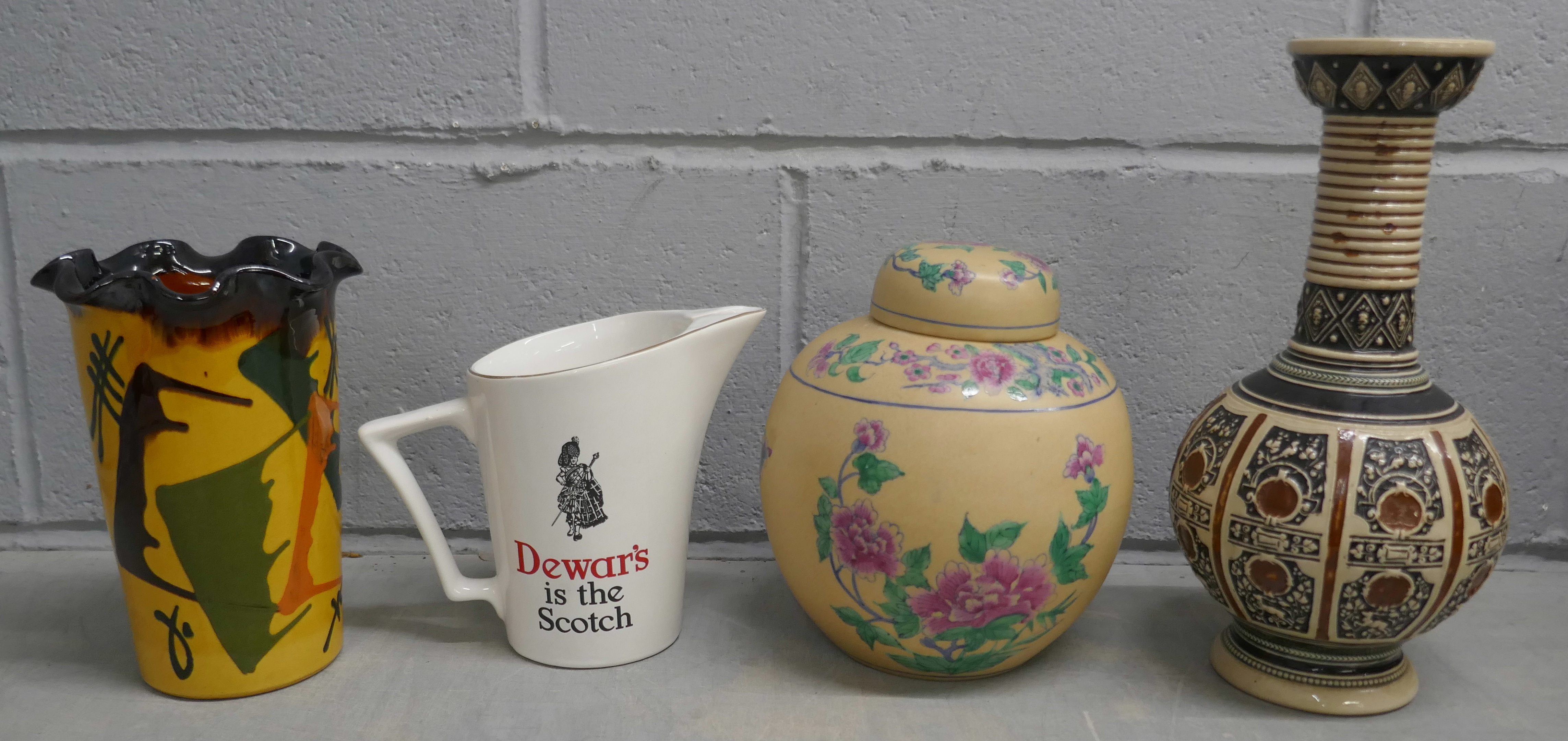 Four items of pottery; a lidded vase, two other vases and a Wade Dewar's Whisky water jug **PLEASE