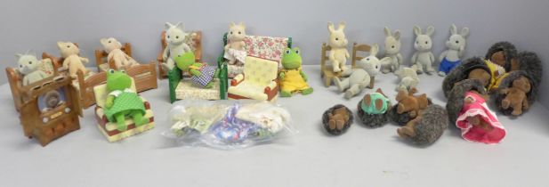 A box of Sylvanian Families and furniture