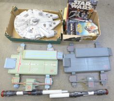 A Star Wars Millennium Falcon model, two light sabers, two landing ports and a collection of Star