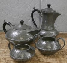 A Craftsman Arts and Crafts four piece hammered pewter tea service