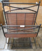 A wrought iron and wicker magazine rack