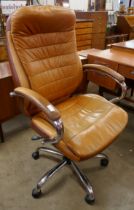 A tan leather and chrome revolving desk chair