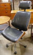 An Eames style simulated rosewood, chrome and black leather revolving desk chair