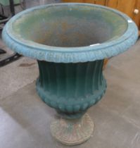 A large cast iron campana shaped garden urn