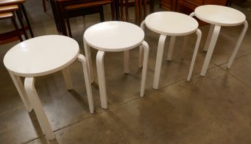 A set of four painted beech and bent plywood stools