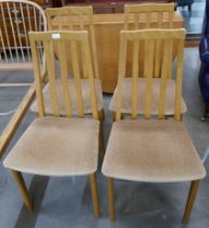 A Jentique teak drop leaf table and four dining chairs