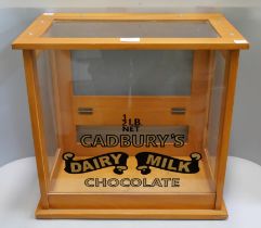 An oak counter top shop cabinet, bearing Cadbury's Dairy Milk inscription