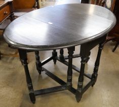 A black oak drop leaf table and a Delft rack