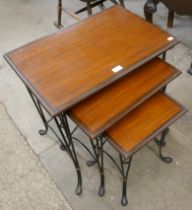 An Italian style teak and wrought iron nest of tables