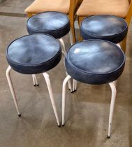 A set of four white tubular metal and blue vinyl seated circular stools