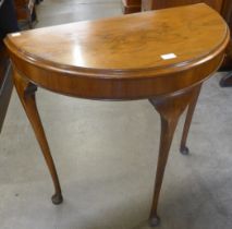 A walnut demi-lune hall table