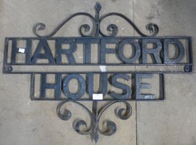 A metal house sign