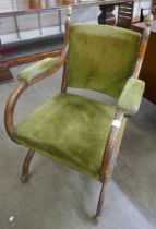 A Victorian oak and green fabric X frame chair