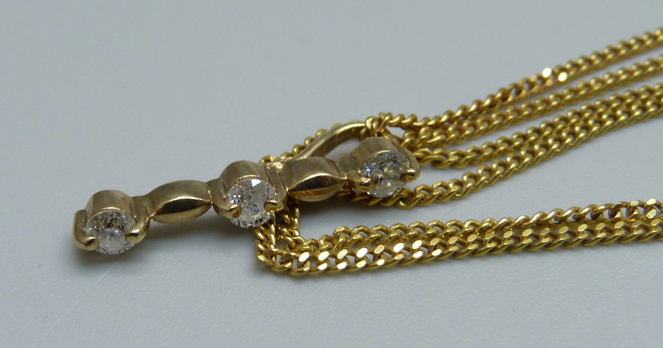 A 9ct gold and three diamond pendant on a 9ct gold chain and a pair of 9ct gold and diamond - Bild 3 aus 3