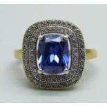 A silver gilt, blue and white stone cluster ring, Q