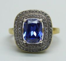 A silver gilt, blue and white stone cluster ring, Q