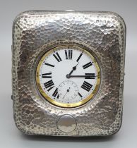 A silver fronted travel case with oversized pocket watch