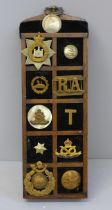 A display of early 20th Century regimental buttons and badges and some loose buttons