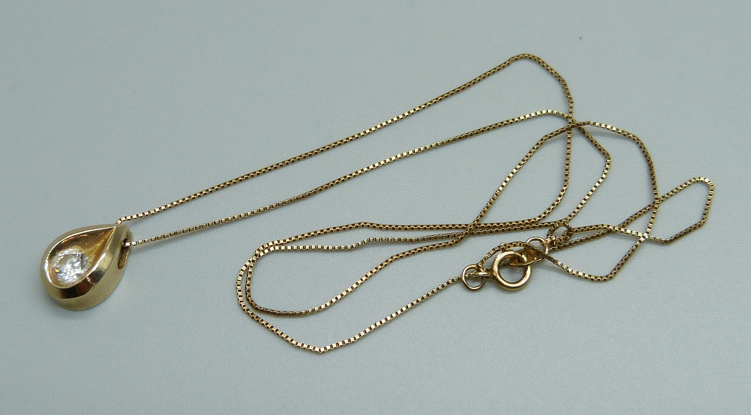 A 14ct gold and diamond pendant on a 14ct gold chain, approximately 0.4ct diamond weight, 3g,