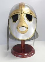 A 'Sutton Hoo' replica helmet and stand