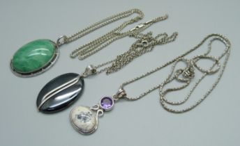 Three silver neck chains and three silver mounted pendants