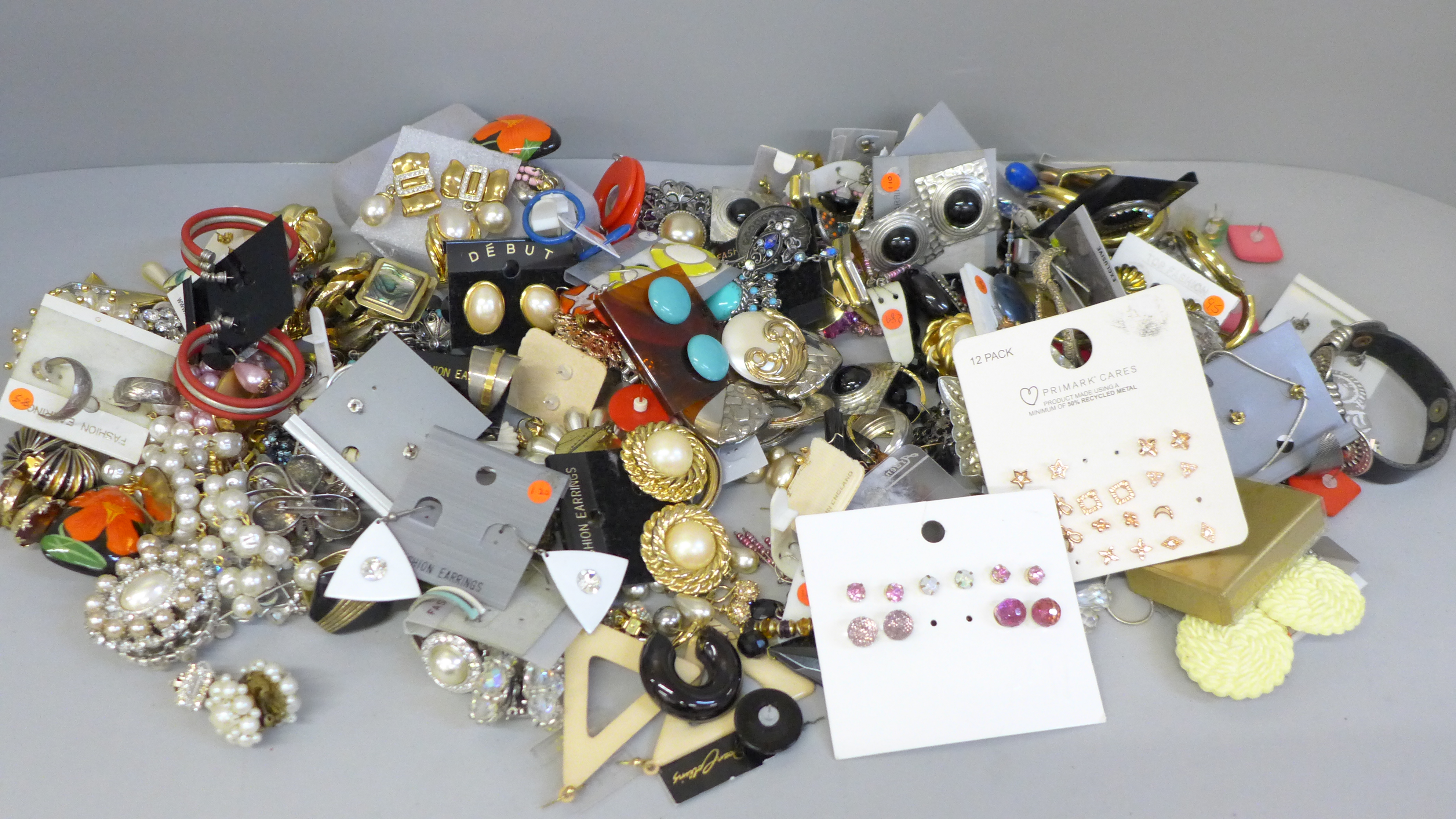 A large collection of vintage earrings, clip-on and pierced