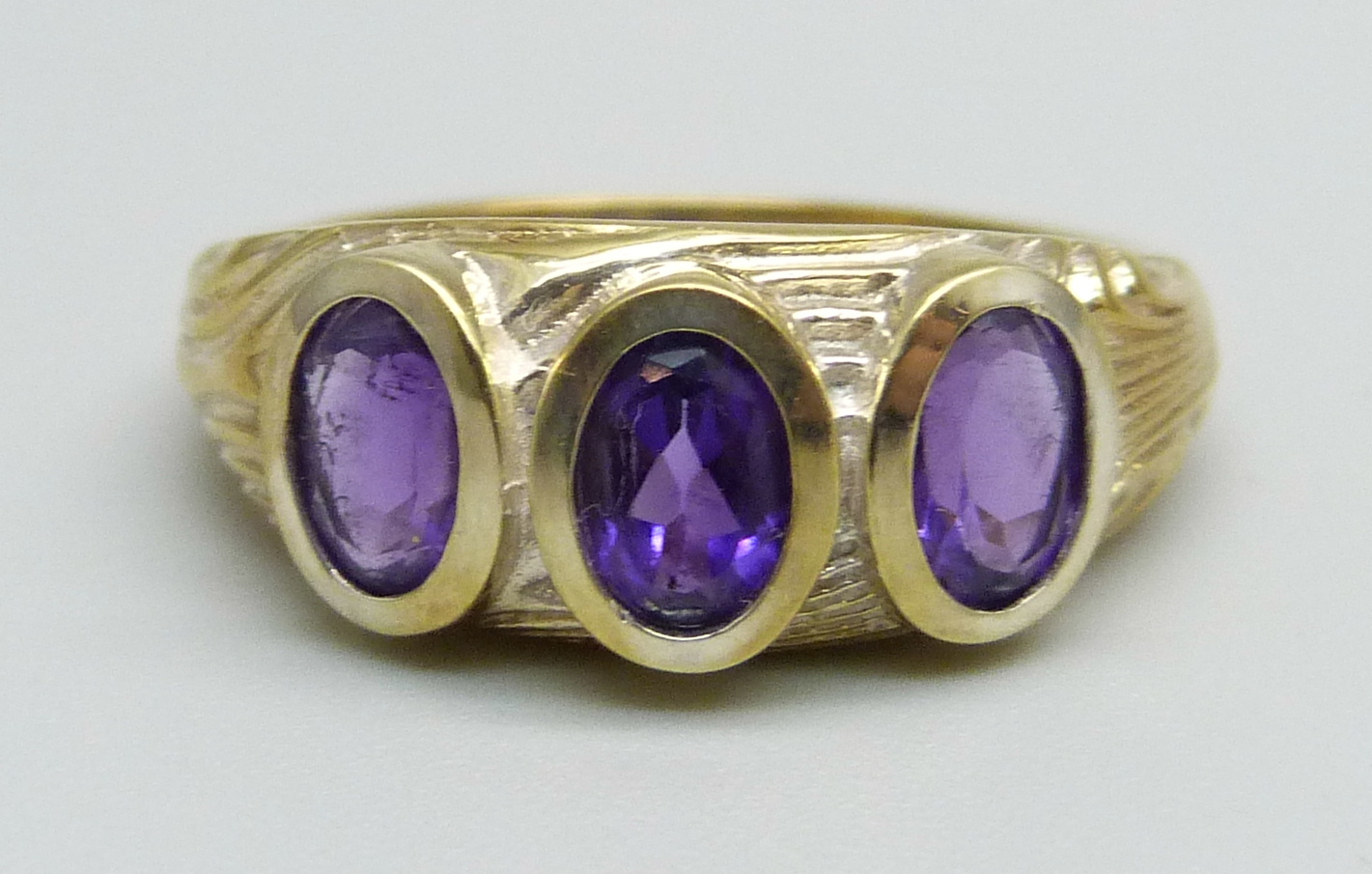 A silver gilt and three stone amethyst ring, O/P