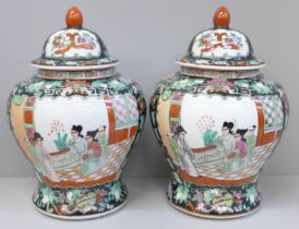 A pair of Chinese porcelain famille verte jars with covers, 27cm