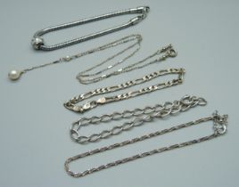 A silver necklace and four silver bracelets