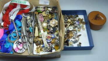 A box of pin badges, cufflinks, etc.