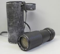 A Minolta Rokkor 1:5.6 f=100-200mm camera lens with case