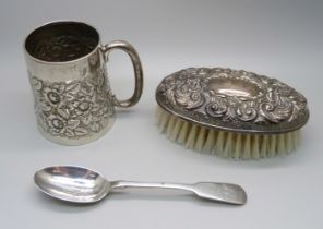 A late Victorian silver mug, Birmingham 1899, a silver spoon and a silver backed brush, (mug and