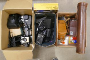 Three boxes of vintage cameras including Polaroid, box Brownie, tripod in leather case, etc. **