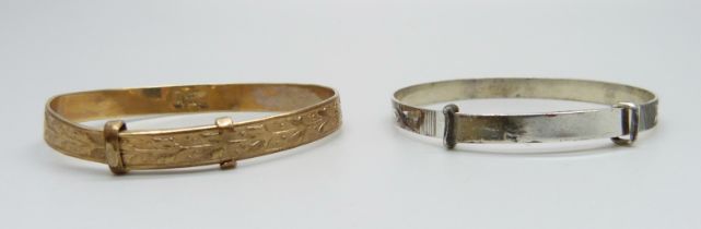 A rolled gold bangle and a silver bangle, small sizes