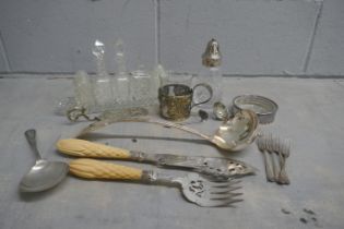 A glass cruet set and sugar shaker, serving spoon, etc. **PLEASE NOTE THIS LOT IS NOT ELIGIBLE FOR