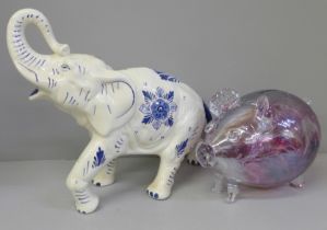 A large hand painted Delft elephant, 37cm and a pink cased glass pig money box, 19cm