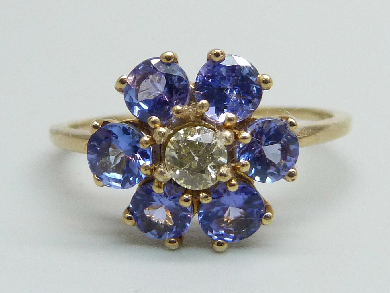 A 9ct gold, tanzanite and diamond cluster ring, 2.6g, U