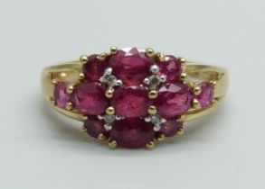 A 9ct gold, eleven ruby and four diamonds set ring, 2.4g, K