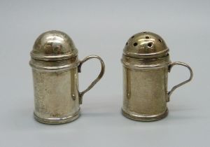 A miniature silver salt and pepper pair, marked on handles