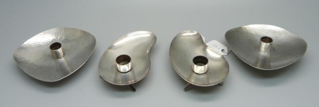 Two pairs of Danish taper candle holders, one pair sterling silver, 73.8g and one pair silver plate,