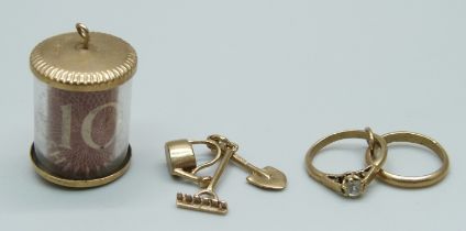 Four 9ct gold charms; spade, watering can and rake; squirrel; rings and 10 shillings note, total